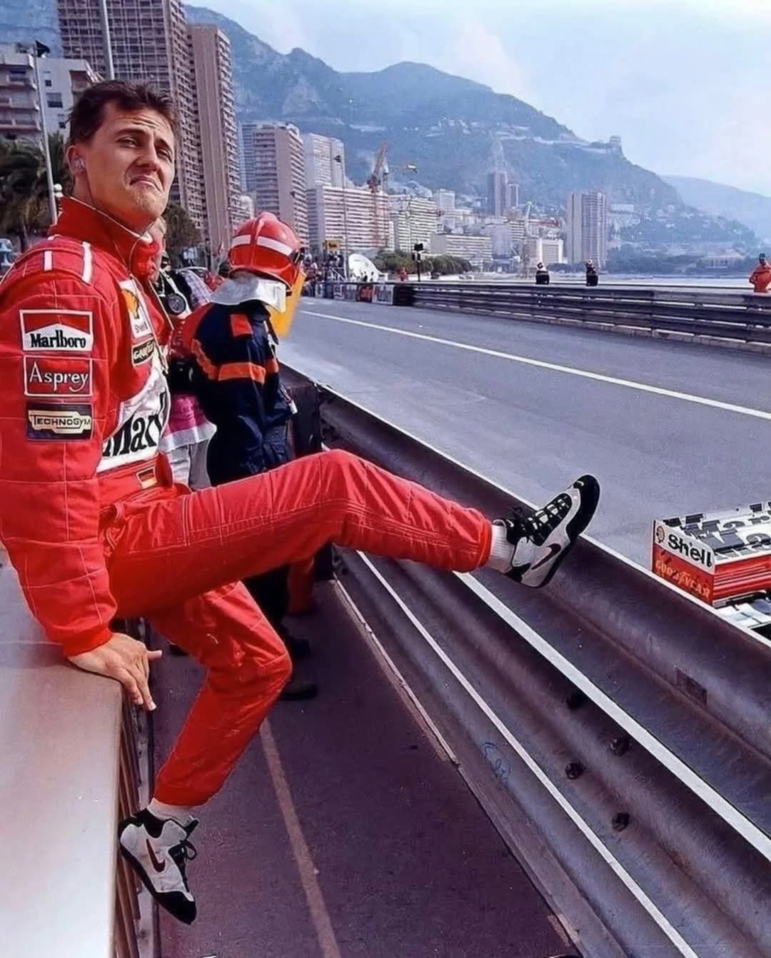 A racing driver sitting beside a city circuit